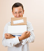 Boy with boxes of parcels in the hands
