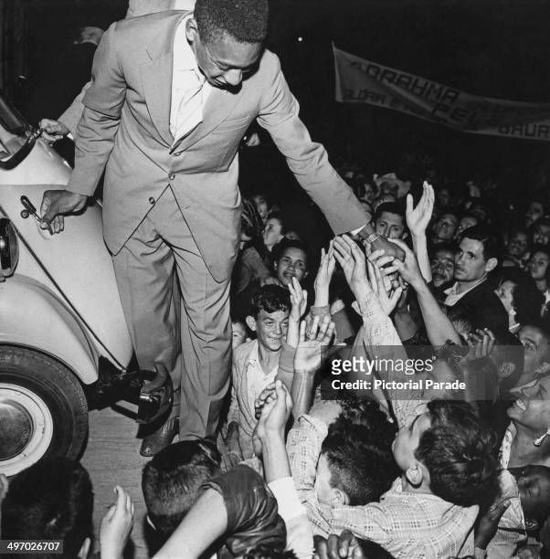 Brazilian footballer Pele and adoring fans with a Romi-Isetta presented by the mayor of Bauru to mark his 1958 World Cup victory, 1958.