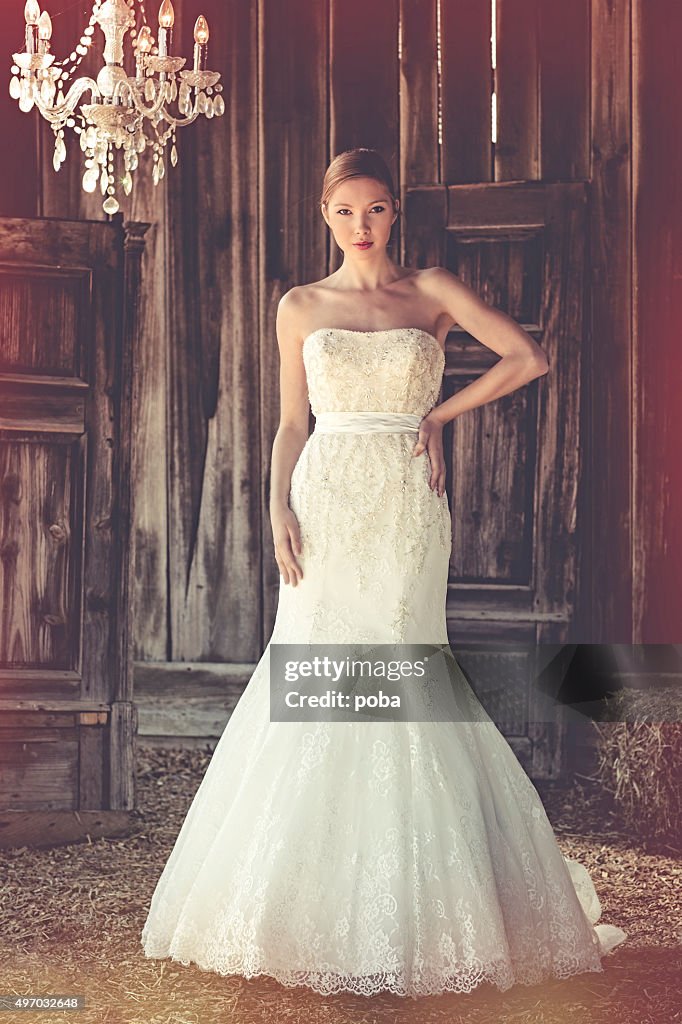 Woman standing in her long wedding dress