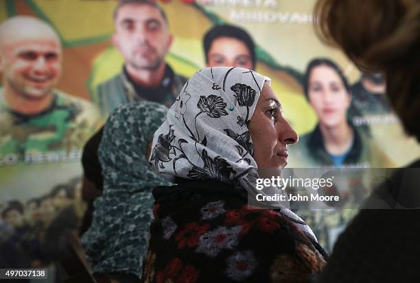 Residents take part in a commune meeting at a Mala Gel or People's House on November 13, 2015 in Derek, in autonomous Rojava, Syria. Portraits of...