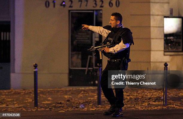 Police survey the area of Boulevard Baumarchais after an attack in the French capital on November 13, 2015 in Paris, France. At least 18 people were...