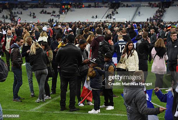 Spectators gather on the pitch of the Stade de France stadium following the International Friendly match between France and Germany at the Stade de...