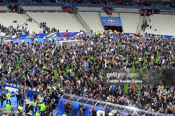 Spectators wait on the pitch of the during the International Friendly game between France and Germany at Stade de France on November 13, 2015 in...