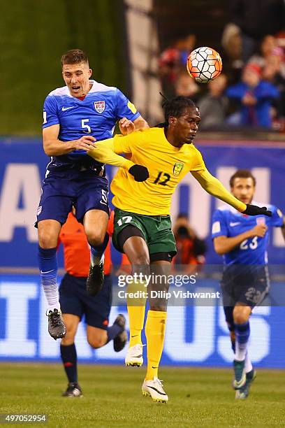 Matt Besler of the United States and Tevin Slater of St. Vincent and the Grenadines compete for a header during a World Cup qualifying match at Busch...