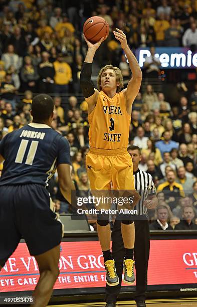 Guard Ron Baker of the Wichita State Shockers puts up a shot against forward Wesley Johnson of the Charleston Southern Buccaneers during the first...