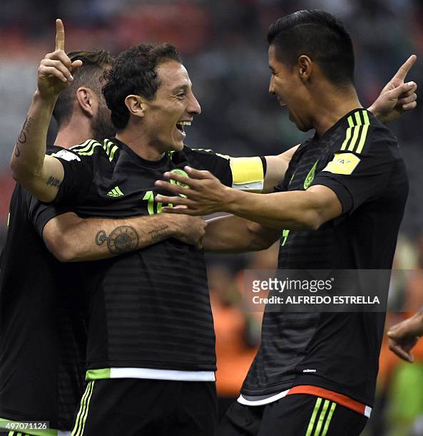 Mexico's Andres Guardado celebrates with teammates Miguel Layun and Hugo Ayala after scoring against El Salvador during their Russia 2018 FIFA World...