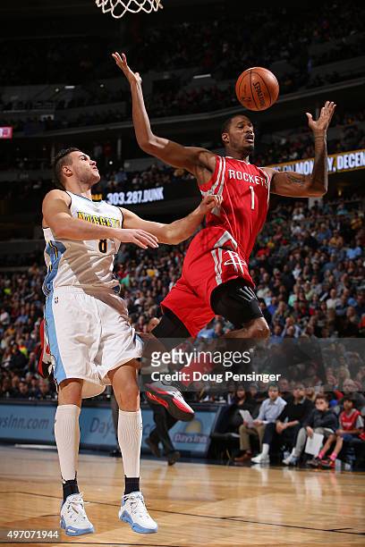 Trevor Ariza of the Houston Rockets is fouled by Danilo Gallinari of the Denver Nuggets as he goes up for a shot at Pepsi Center on November 13, 2015...