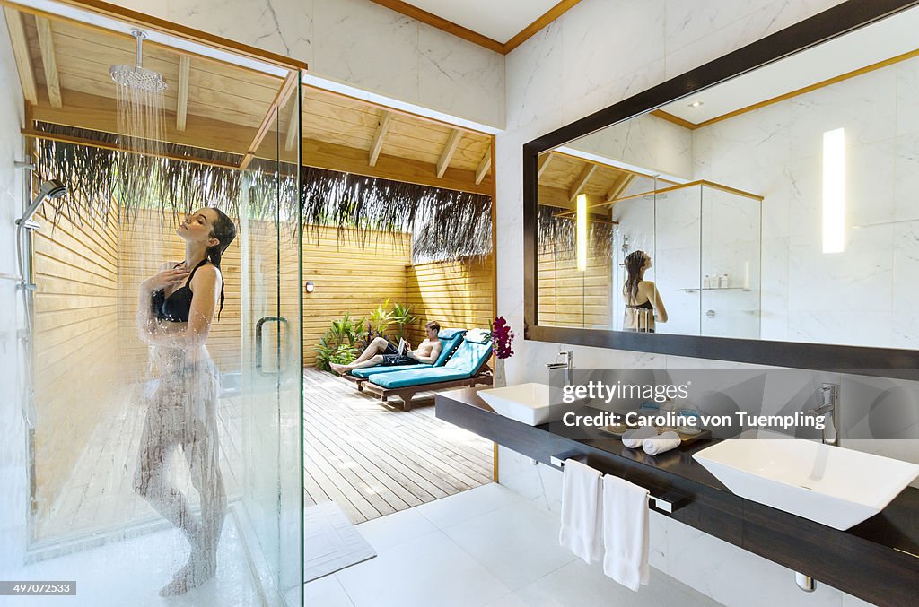 Young couple relaxing in resort bungolow bathroom