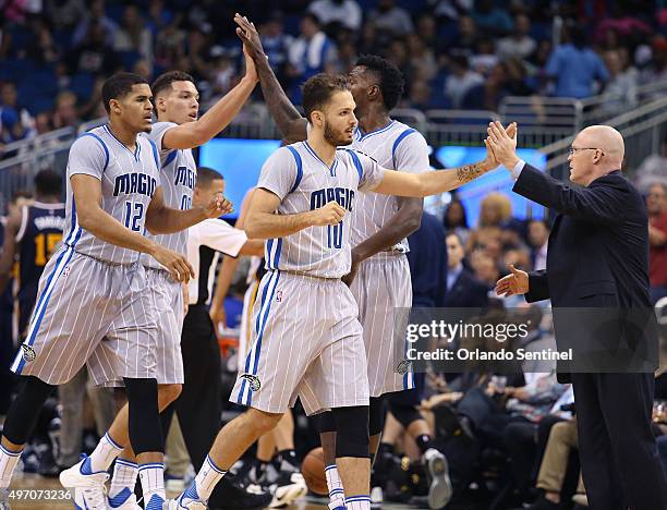 Orlando Magic head coach Scott Skiles, right, celebrates with players Tobias Harris , Aaron Gordon , Evan Fournier , and Dewayne Dedmon a 102-93 win...