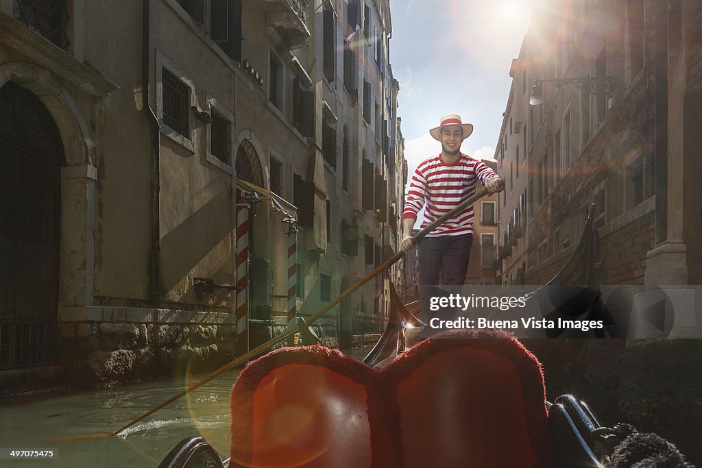 Venice, gondolier on gondola in a channel