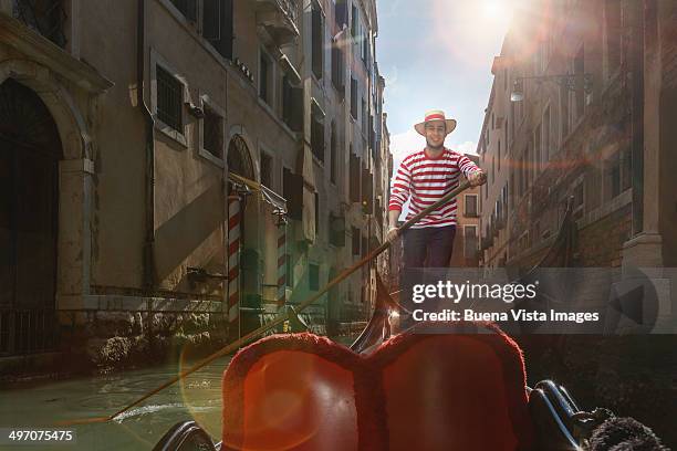 venice, gondolier on gondola in a channel - gondolier stock pictures, royalty-free photos & images