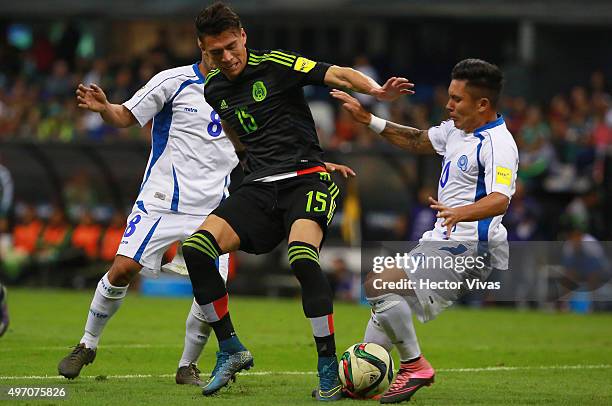 Hector Moreno of Mexico struggles for the ball with Diego Chavarria and Jaime Alas of El Salvador during the match between Mexico and El Salvador as...