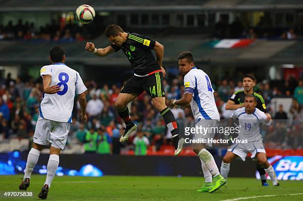 Javier Hernandez of Mexico struggles for the ball with Diego Chavarria and Henry Romero of El Salvador during the match between Mexico and El...