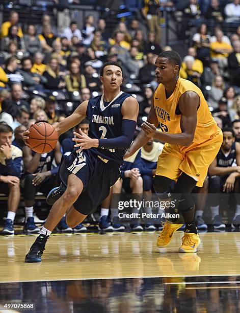 Guard Aaron Wheler of the Charleston Southern Buccaneers drives to the basket against forward Anton Grady of the Wichita State Shockers during the...