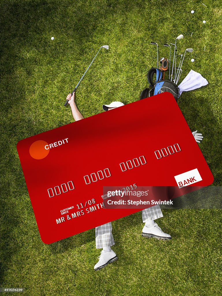 Man golfing crushed under oversized credit card