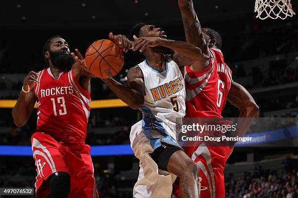 Will Barton of the Denver Nuggets has his shot blocked by James Harden of the Houston Rockets as Terrence Jones of the Houston Rockets helps with the...