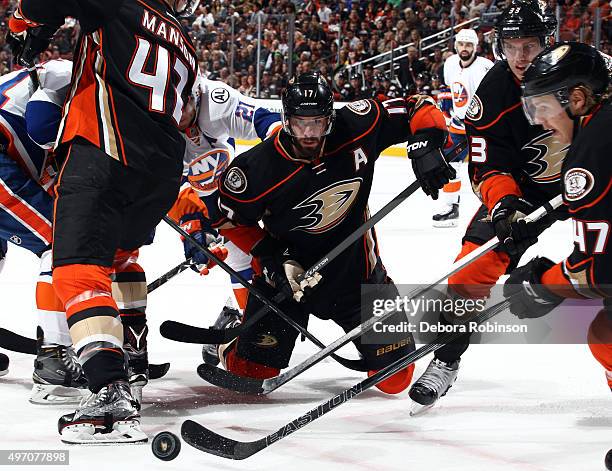 Ryan Kesler, Jakob Silfverberg and Hampus Lindholm of the Anaheim Ducks vie for the puck against the New York Islanders on November 13, 2015 at Honda...