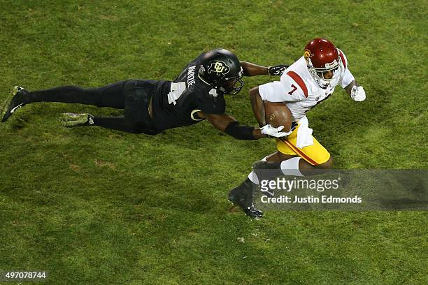 Wide receiver Steven Mitchell Jr. #7 of the USC Trojans eludes defensive back Chidobe Awuzie of the Colorado Buffaloes after making a reception...