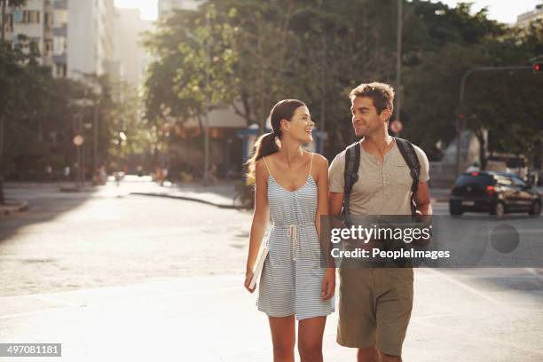 enjoying the sights on their vacation - young couple exploring city stock pictures, royalty-free photos & images