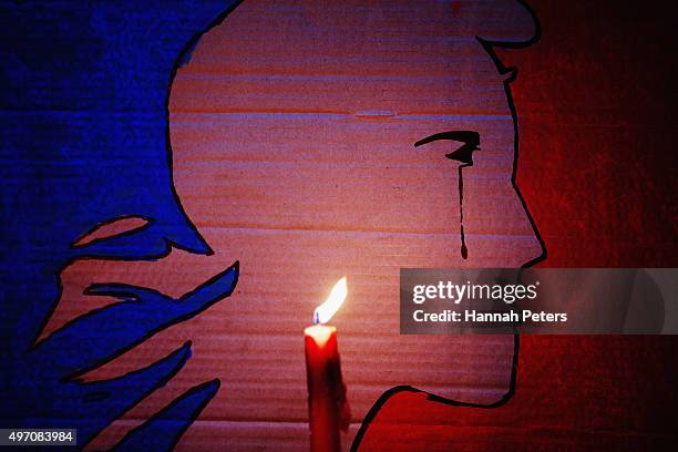 Candle burns during a vigil in Aotea Square to remember victims of the Paris attacks on November 14, 2015 in Auckland, New Zealand. According to...