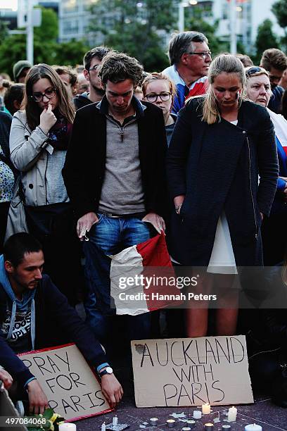 People gather during a vigil in Aotea Square to remember victims of the Paris attacks on November 14, 2015 in Auckland, New Zealand. According to...