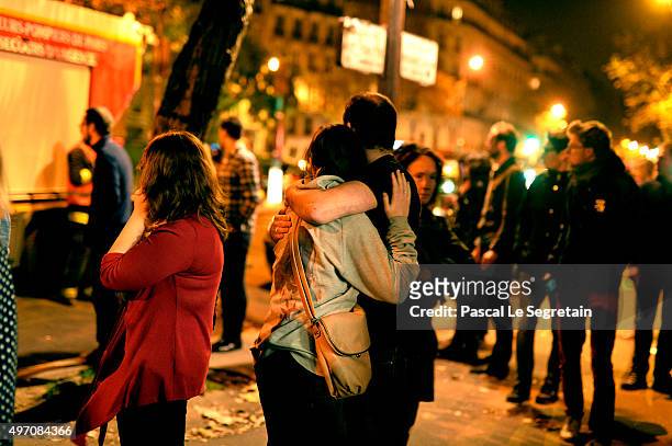 Parisians look at the scene outside the Bataclan concert hall after an attack on November 13, 2015 in Paris, France. According to reports, over 120...