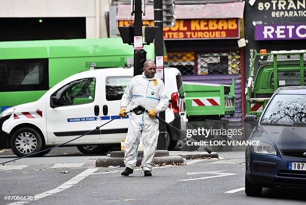 Crime scene cleaner is pictured at the Rue de Charonne in Paris on November 14 following a series of coordinated attacks in and around Paris late...