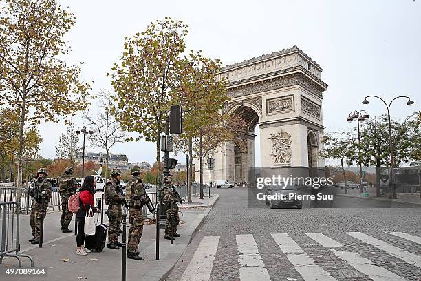 Ambiance outside the Arc De Triomphe as soldiers patrol in front of the Arc De Triomphe on November 14, 2015 in Paris, France. At least 120 people...