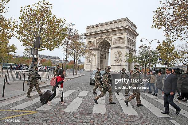 Ambiance outside the Arc De Triomphe as soldiers patrol in front of the Arc De Triomphe on November 14, 2015 in Paris, France. At least 120 people...