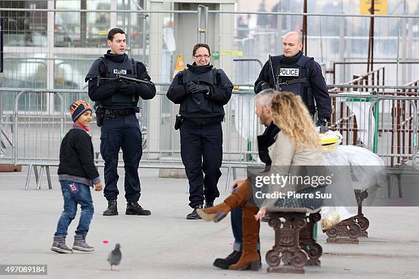 Ambiance outside the Arc De Triomphe as police patrol in front of the Arc De Triomphe on November 14, 2015 in Paris, France. At least 120 people have...