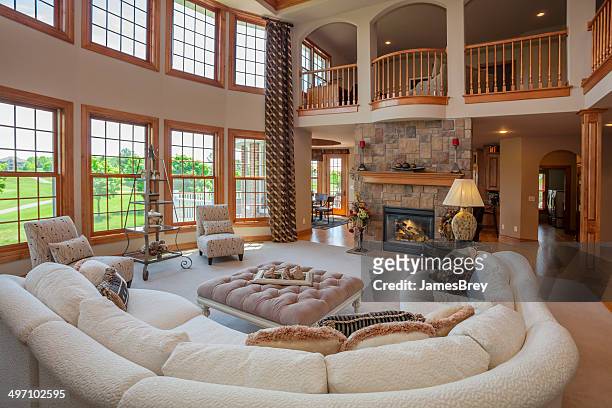 amazing great room with second story balcony - luxury mansion interior stock pictures, royalty-free photos & images