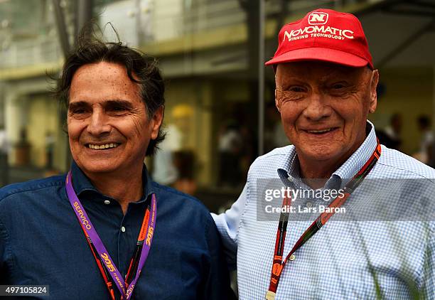 Mercedes GP non-executive chairman Niki Lauda speaks with Nelson Piquet in the paddock before final practice for the Formula One Grand Prix of Brazil...