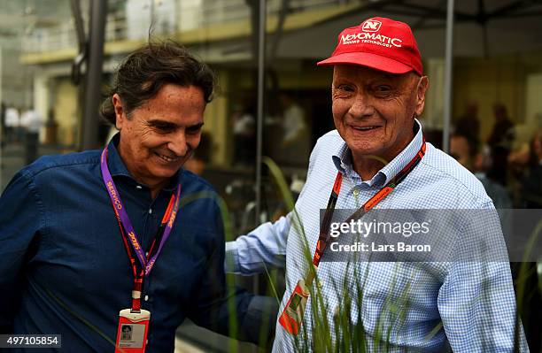 Mercedes GP non-executive chairman Niki Lauda speaks with Nelson Piquet in the paddock before final practice for the Formula One Grand Prix of Brazil...