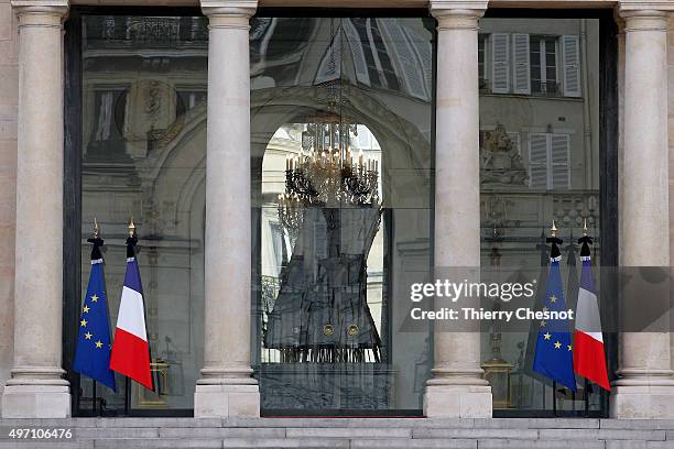 French flags are set at half mast after French president Francois Hollande declared three days of national mourning, at the Elysee Palace on November...