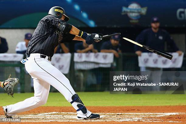 Outfielder Yoshitomo Tsutsugo of Japan hits a RBI single with breaking his bat in the top of sixth inning during the WBSC Premier 12 match between...