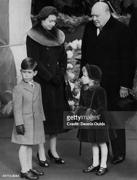 Queen Elizabeth II chats to British Prime Minister Sir Winston Churchill whilst waiting at Waterloo Station in London with Prince Charles and...