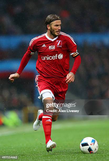 David Beckham of Great Britain and Ireland runs with the ball during the David Beckham Match for Children in aid of UNICEF between Great Britain &...