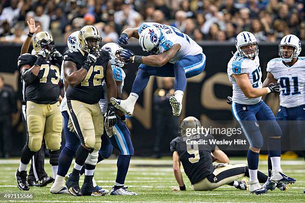 Angelo Blackson of the Tennessee Titans jumps in the air in celebration after sacking Drew Brees of the New Orleans Saints at Mercedes-Benz Superdome...