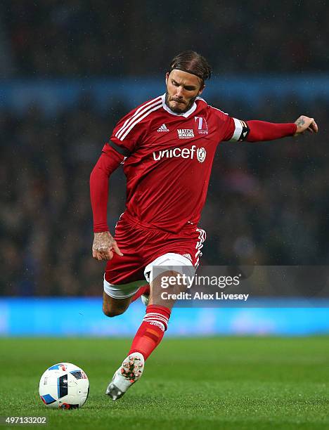 David Beckham of Great Britain and Ireland passes the ball during the David Beckham Match for Children in aid of UNICEF between Great Britain &...