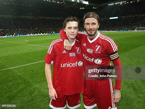 David Beckham of Great Britain and Ireland poses with his son Brooklyn Beckham after the David Beckham Match for Children in aid of UNICEF between...