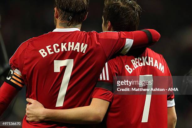 David Beckham of Great Britain and Ireland XI with his son Brooklyn during the David Beckham Match for Children in aid of UNICEF at Old Trafford on...