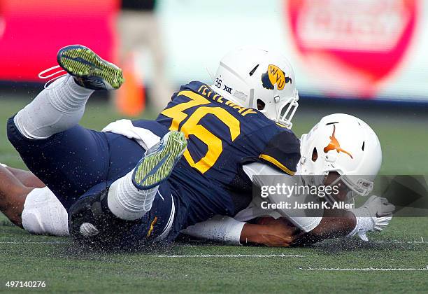 Jerrod Heard of the Texas Longhorns recovers a fumbled snap against Shaq Petteway of the West Virginia Mountaineers in the first half during the game...