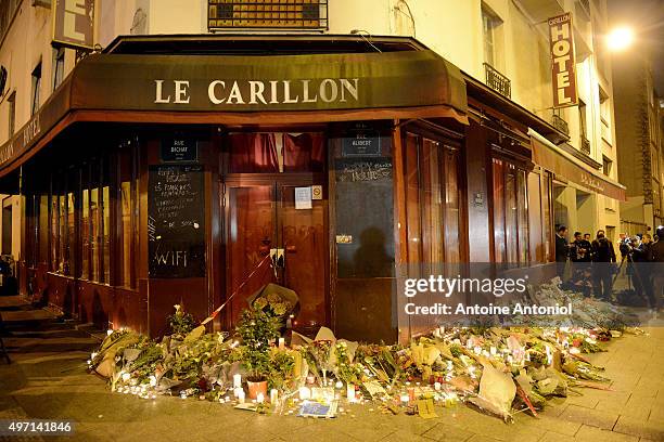 Flowers and candles are placed outside Le Carillon bar, the day after a deadly attack on November 14, 2015 in Paris, France. At least 120 people have...