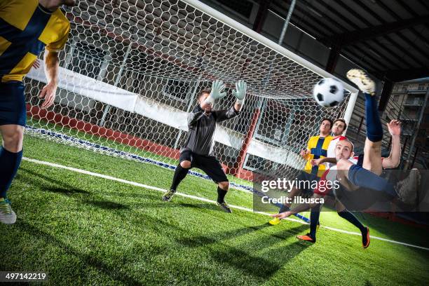 football match in stadium: bicycle kick - bicycle kick stock pictures, royalty-free photos & images