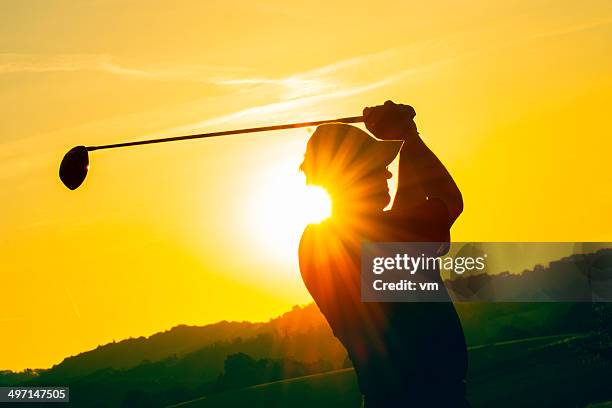 golfer at sunset - golf swing sunset stock pictures, royalty-free photos & images
