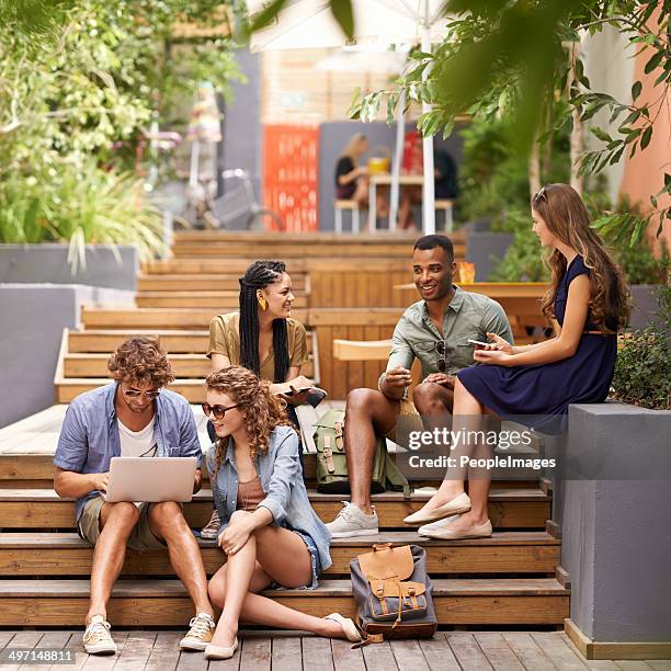 during their breaks they look for a digital escape! - male college student sitting on campus steps stock pictures, royalty-free photos & images