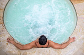 Man relaxing in a hot tub