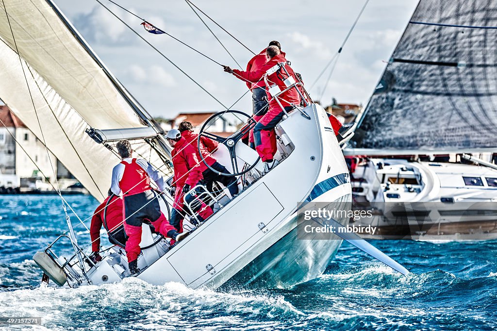 Sailing crew on sailboat during regatta
