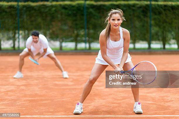 couple playing tennis - mixed doubles stockfoto's en -beelden