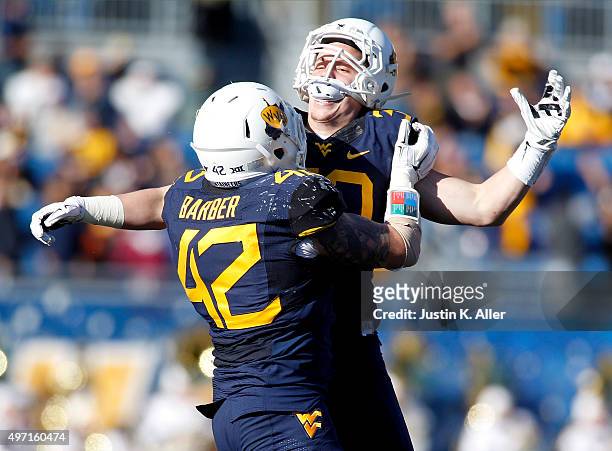 Justin Arndt of the West Virginia Mountaineers celebrates after recovering a fumble on a kick return in the second half during the game against the...